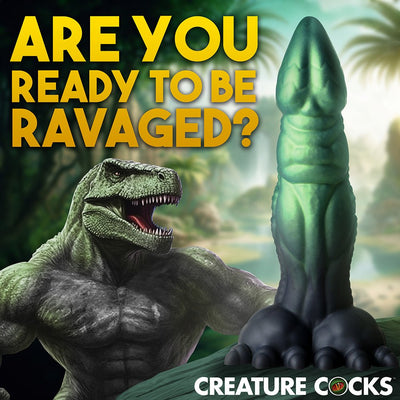 Green and black textured dinosaur-themed silicone dildo with clawed feet and a muscular T-Rex illustration in the background.