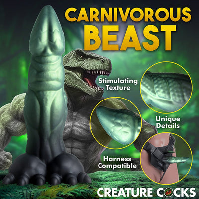 Green and black dinosaur-themed dildo with textured shaft, clawed base, and harness compatibility shown in fantasy setting.