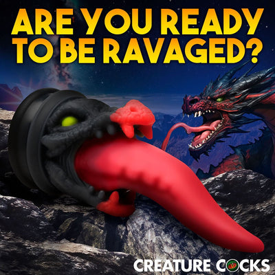 Red and black dragon-themed dildo with a long tapered tongue and suction cup base against a rocky night background.