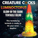 Colorful glow-in-the-dark tentacle dildo with suction cup base, featuring textured suckers and vibrant rainbow hues.