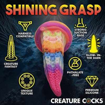 Rainbow-colored tentacle dildo with suction cup base, textured suckers, glow-in-the-dark feature, and harness compatibility.