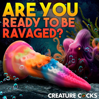 Rainbow-colored silicone tentacle dildo with suction cup base, underwater fantasy background, and bold text overlay.