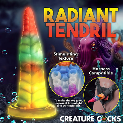 Rainbow-colored glowing tentacle dildo with textured suckers, suction cup base, and harness compatibility shown in underwater fantasy setting.