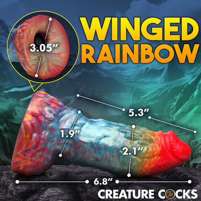 Rainbow-colored textured fantasy dildo with detailed measurements and suction cup base shown against a mountain background.
