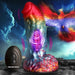 Iridescent rainbow silicone dildo with textured shaft and suction base, shown with black remote control and phoenix illustration background.