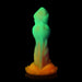 Glow-in-the-dark silicone dildo with textured ridges and a flared orange base, featuring a gradient from green to orange.