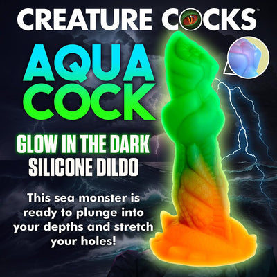 Glow-in-the-dark silicone dildo with vibrant green and orange sea creature design and textured surface.