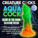Glow-in-the-dark silicone dildo with vibrant green and orange sea creature design and textured surface.