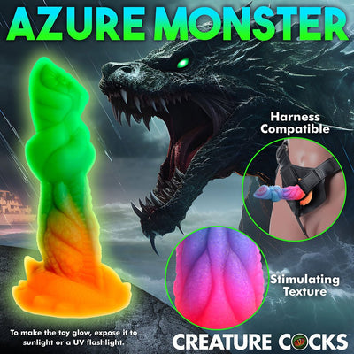 Glow-in-the-dark green and orange sea creature dildo with textured ridges and harness compatibility shown against a dark ocean monster background.