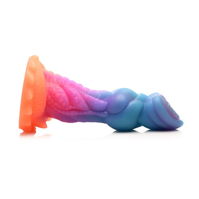 Colorful silicone fantasy dildo with textured ridges, bumps, and a suction cup base in shades of blue, purple, pink, and orange.