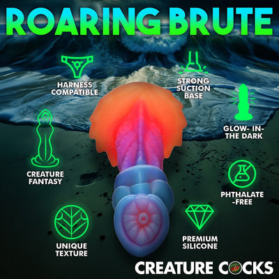 Colorful fantasy-themed dildo with textured ridges and suction cup base, shown with icons highlighting harness compatibility and glow-in-the-dark feature.