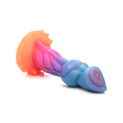 Colorful silicone fantasy dildo with textured ridges and suction cup base in shades of blue, pink, purple, and orange.