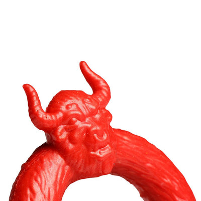 Bright red silicone c-ring featuring a detailed bull head with horns, designed for enhanced performance and fantasy play.