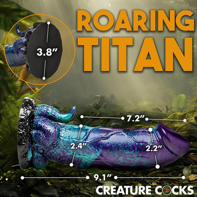 Blue, purple, and teal glittery dinosaur-themed dildo with detailed measurements and suction cup base shown on forest background.