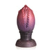 Large dragon egg-shaped silicone plug with textured ridges and tapered tip in red and purple gradient colors.
