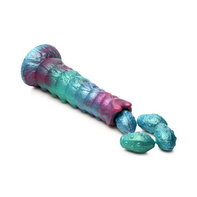 Iridescent teal, blue, and red segmented ovipositor dildo with textured shaft and four detachable squishy eggs on white background.