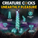 Iridescent teal, red, and blue alien-inspired ovipositor dildo with textured bumps and four egg-like shapes at the base, shown with product features.