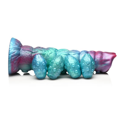 Iridescent teal, blue, and red segmented ovipositor dildo with textured shaft and four detachable egg-shaped pieces on a white background.