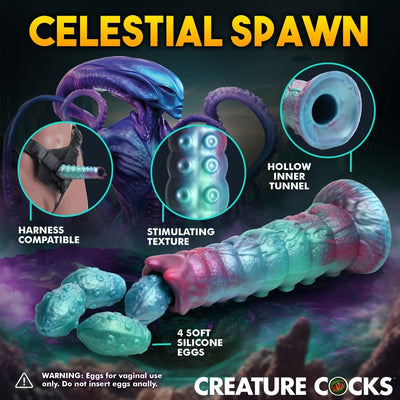 Iridescent teal and pink alien-themed ovipositor dildo with textured shaft, hollow tunnel, and four soft silicone eggs, harness compatible.