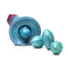 Iridescent teal, blue, and red alien-inspired ovipositor dildo with textured segmented shaft and four removable squishy eggs.