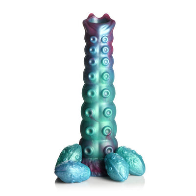 Iridescent teal, blue, and red textured ovipositor dildo with four detachable squishy eggs on a white background.