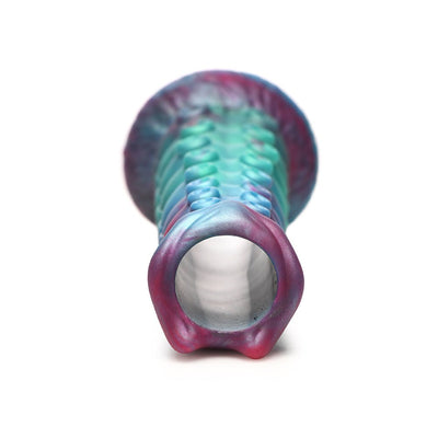 Close-up of a teal, blue, and red iridescent ovipositor dildo with textured segmented shaft and hollow open tip.