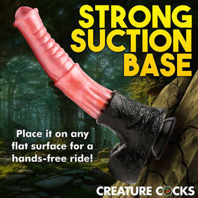 Peach and black centaur-themed dildo with ribbed shaft and strong suction cup base against a forest background.