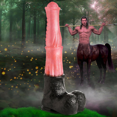 Peach and black centaur-themed fantasy dildo with suction base displayed in a mystical forest setting with a centaur figure in the background.
