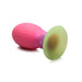 Large multi-color glow-in-the-dark silicone egg with ribbed pink body and green base for textured stimulation.