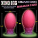 Two glow-in-the-dark silicone eggs in pink, purple, and green with textured bases, shown in large and extra-large sizes with measurements.