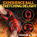 Red and black silicone ball stretcher and girth enhancer held between fingers with fire background and text about ball stretching.