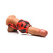 Red and black silicone girth enhancer with ball strap displayed on a realistic male model for size reference.