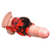 Red and black silicone girth enhancer sleeve with ball strap on a realistic penis model.