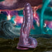 Hydra sea monster dildo in swirling red, blue, and purple with textured three-headed design and suction cup base.