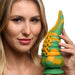 Woman holding a green and yellow marbled silicone tentacle dildo with suction cup base against a white background.