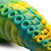 Close-up of green, yellow, and blue marbled silicone dildo with detailed tentacle suction cup texture.