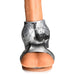 Silver and black silicone girth enhancer and ball strap worn on a realistic flesh-toned model shaft and testicles.