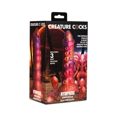 Packaging of Creature Cocks Nymphoid Ovipositor silicone dildo with three soft silicone eggs and alien tentacle design.
