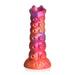 Sunset-colored silicone dildo with textured suction cup-like nodules and a flared base for harness compatibility.