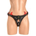 Black and red creature-themed strap-on harness with adjustable buckles and decorative eye and horns on a mannequin.