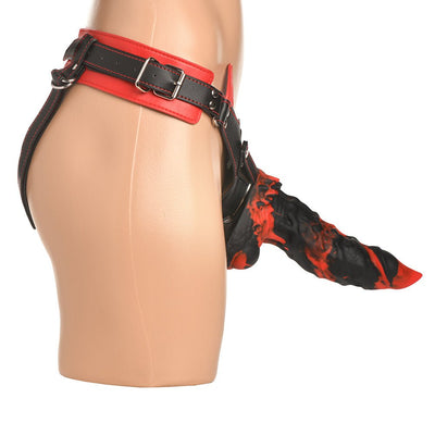 Side view of a mannequin wearing a black and red adjustable strap-on harness with a textured black and red creature-inspired attachment.