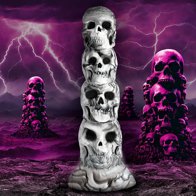 White and gray silicone dildo shaped like a tower of stacked skulls with a suction cup base against a stormy purple lightning background.
