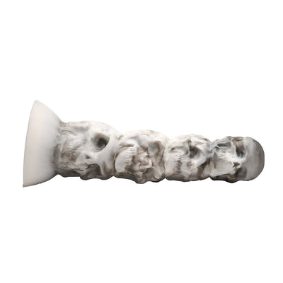 White and gray silicone dildo shaped as a tower of stacked skulls with a suction cup base.