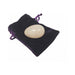 Rose quartz Crystal Egg Kegel massager resting on a dark purple velvet drawstring pouch.