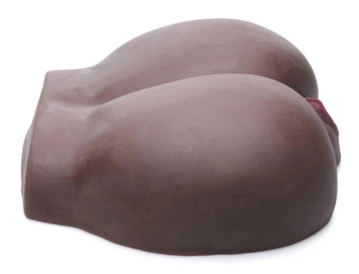 Dark-toned realistic silicone masturbator shaped like a pair of buttocks with detailed texture and lifelike design.