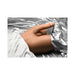 Poseable male masturbator with realistic skin tone and vibrating dildo, displayed on silver satin sheets.