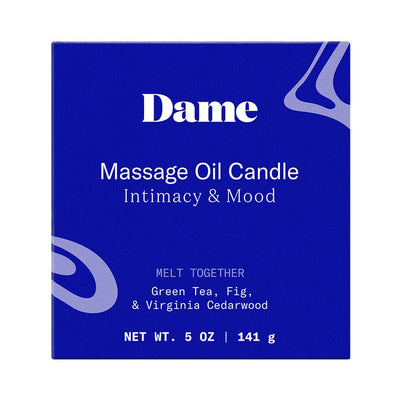 Dame Massage Oil Candle box in deep blue with white text highlighting green tea, fig, and Virginia cedarwood scent.