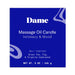 Dame Massage Oil Candle box in deep blue with white text highlighting green tea, fig, and Virginia cedarwood scent.