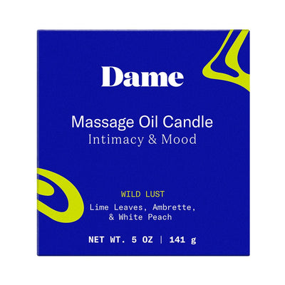 Dame Massage Oil Candle box in blue with green accents, featuring Wild Lust scent with lime leaves, ambrette, and white peach.