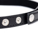 Close-up of black vegan leather choker strap with silver snap button closures and detailed stitching.